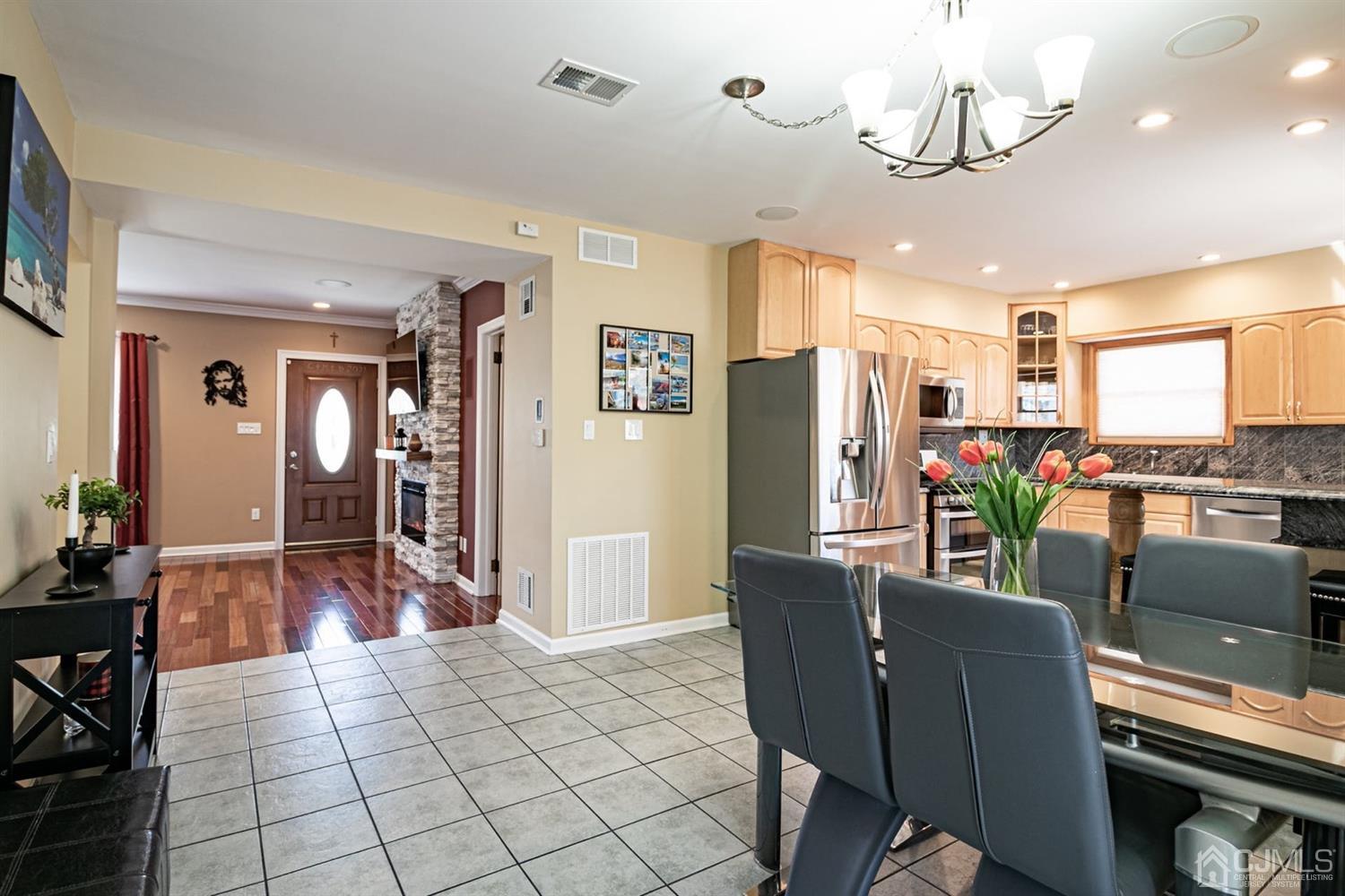 24 Kimberly Road Colonia, NJ 07067 - Photo 8 of 50 a view of a dining room with furniture a kitchen and chandelier