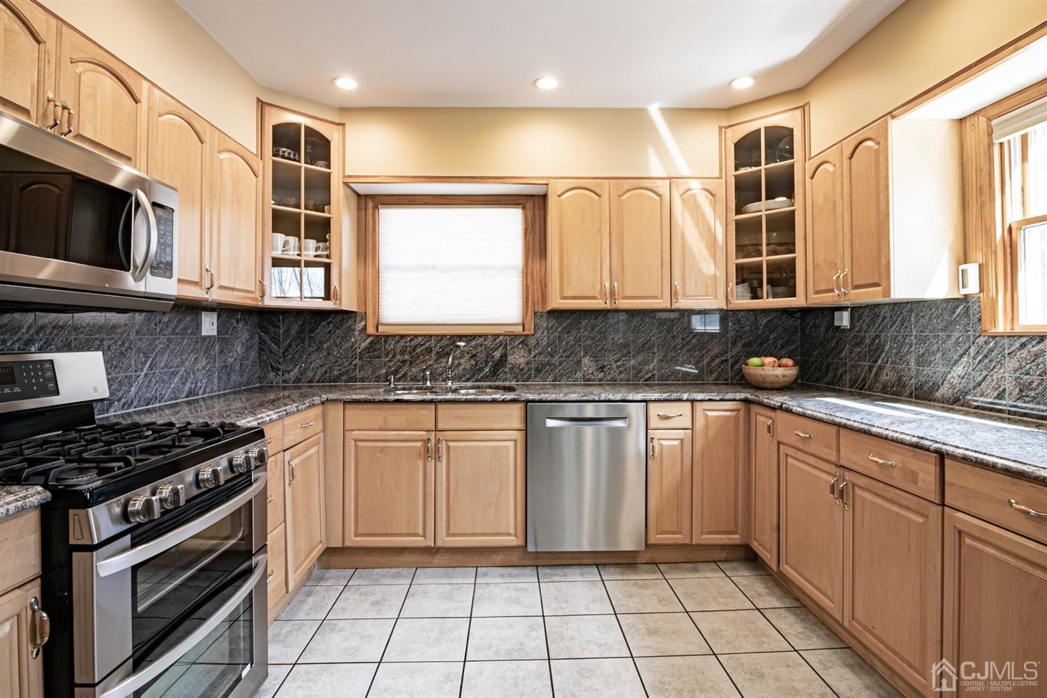 24 Kimberly Road Colonia, NJ 07067 - Photo 10 of 50 a kitchen with stainless steel appliances granite countertop a sink and a stove