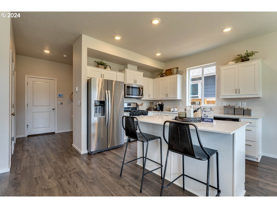 2758 V Street Springfield, OR 97477 - Photo 8 of 24 a kitchen with stainless steel appliances a refrigerator and a stove top oven