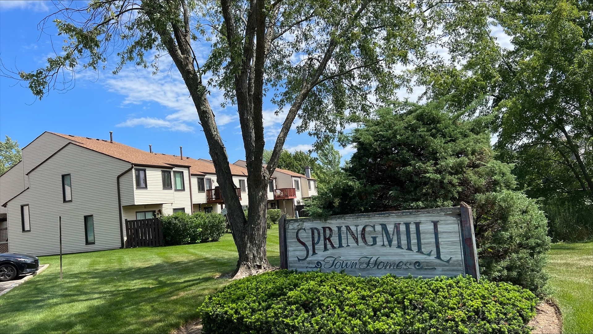 1009 Spring Mill Drive Hoffman Estates, IL 60169 - Photo 31 of 35 a view of a house with a yard and potted plants