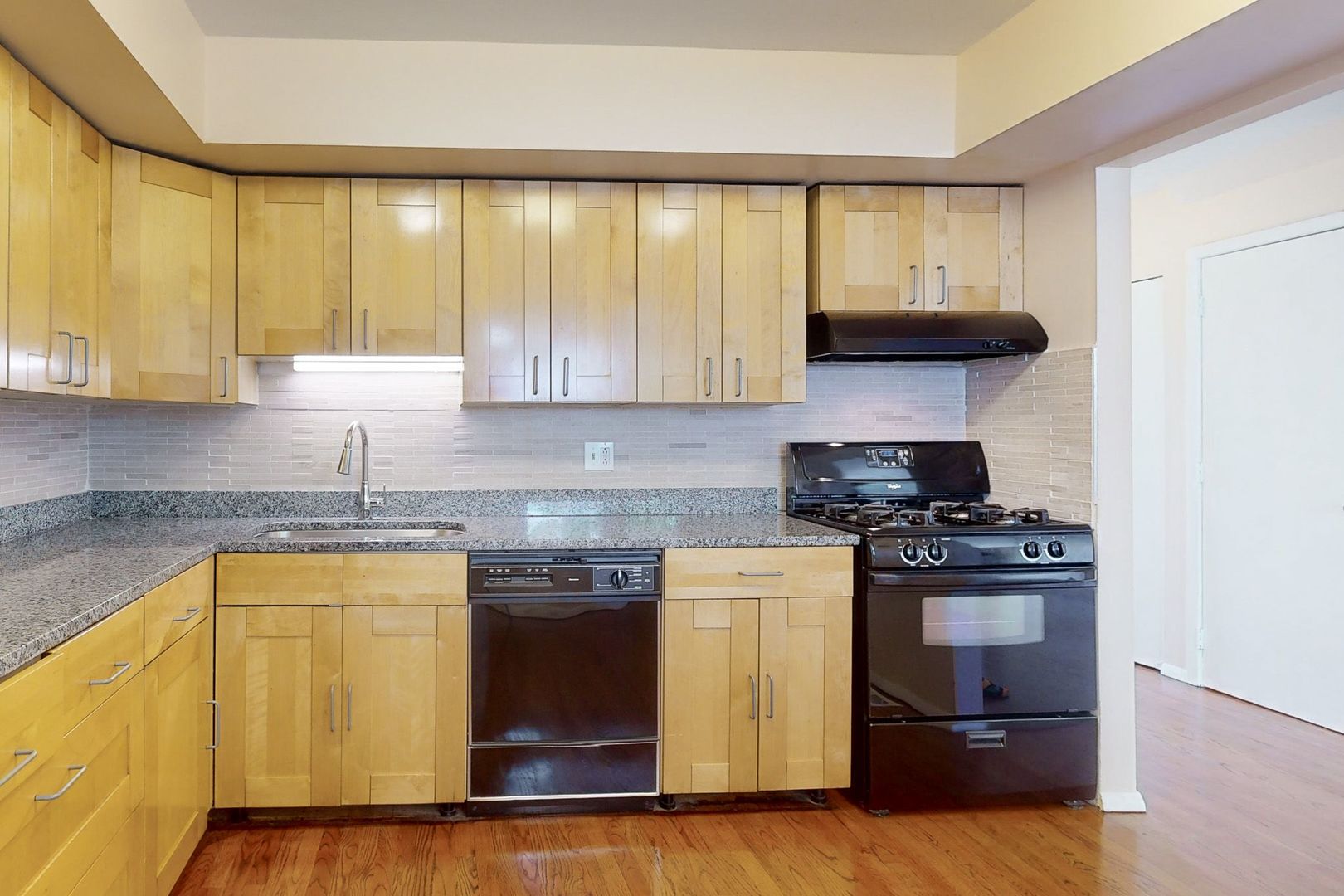 1009 Spring Mill Drive Hoffman Estates, IL 60169 - Photo 6 of 35 a kitchen with a sink a stove and cabinets