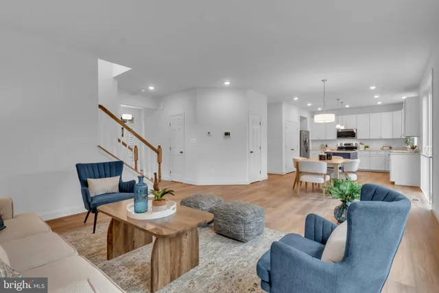 a living room with furniture kitchen view and a table
