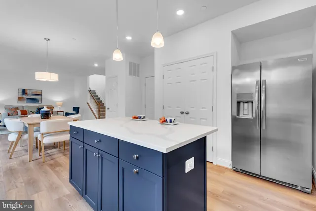 a kitchen with kitchen island a sink appliances and a counter top space
