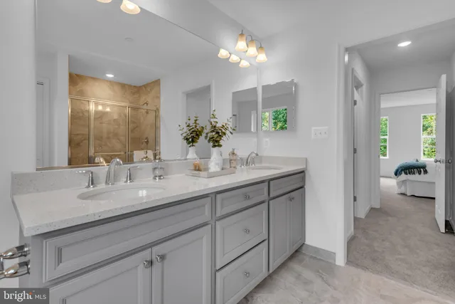 a en suite bathroom with a granite countertop sink and a mirror