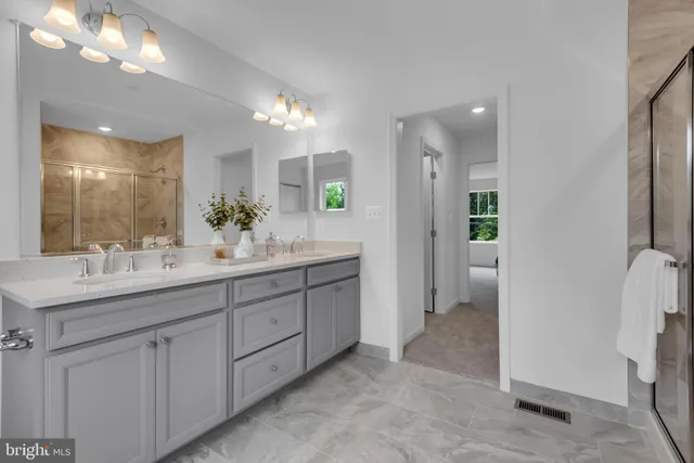a bathroom with a double vanity sink and a mirror