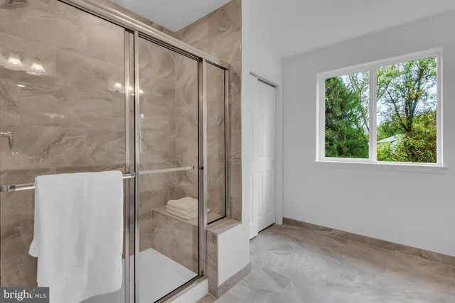 a bathroom with a glass shower door