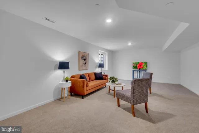 a living room with furniture and a lamp