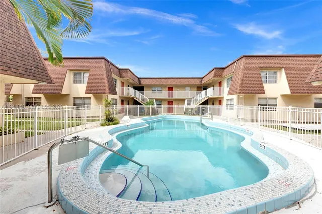 front view of a brick house with a yard