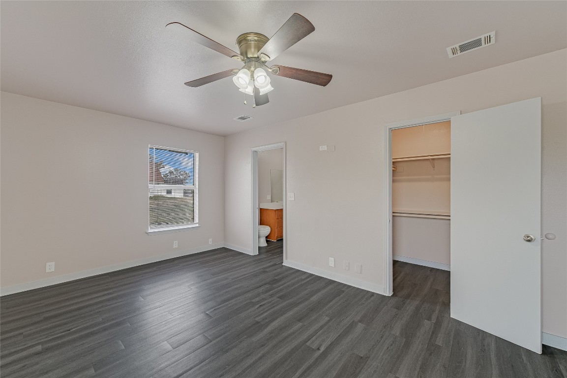 200 Creekside Trail Kyle, TX 78640 - Photo 13 of 19 a view of an empty room with wooden floor and a window
