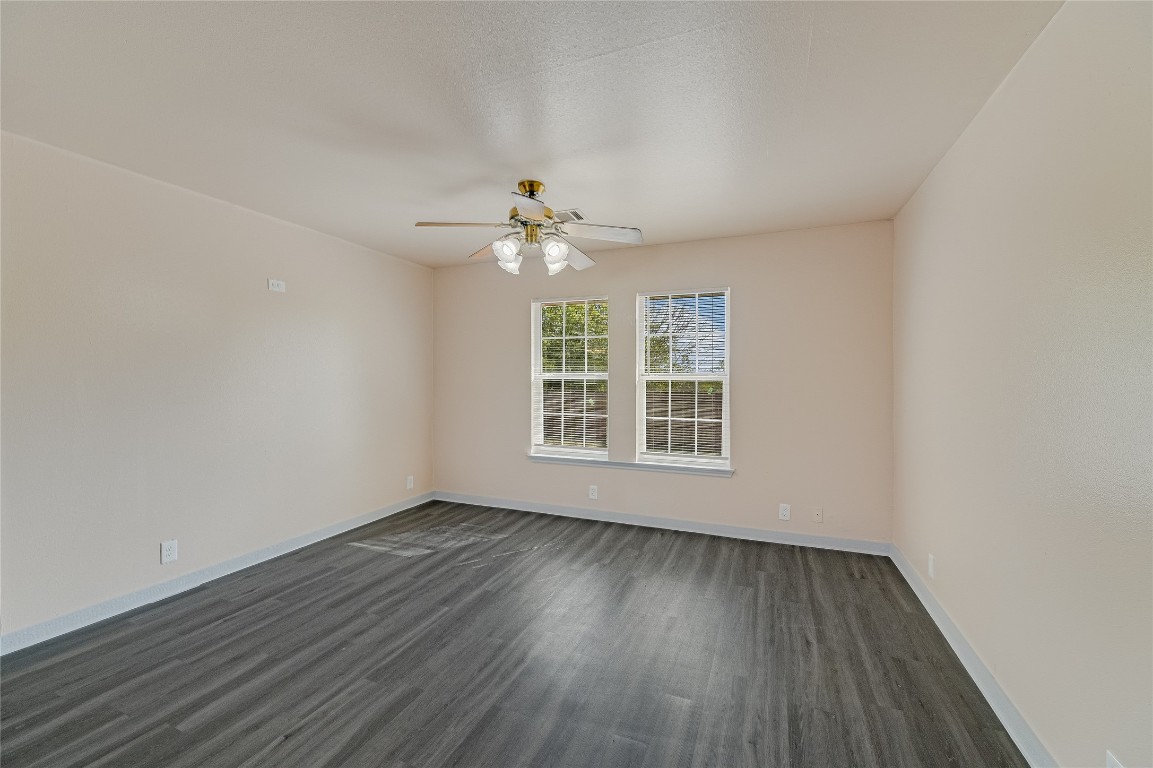 200 Creekside Trail Kyle, TX 78640 - Photo 7 of 19 an empty room with wooden floor and windows