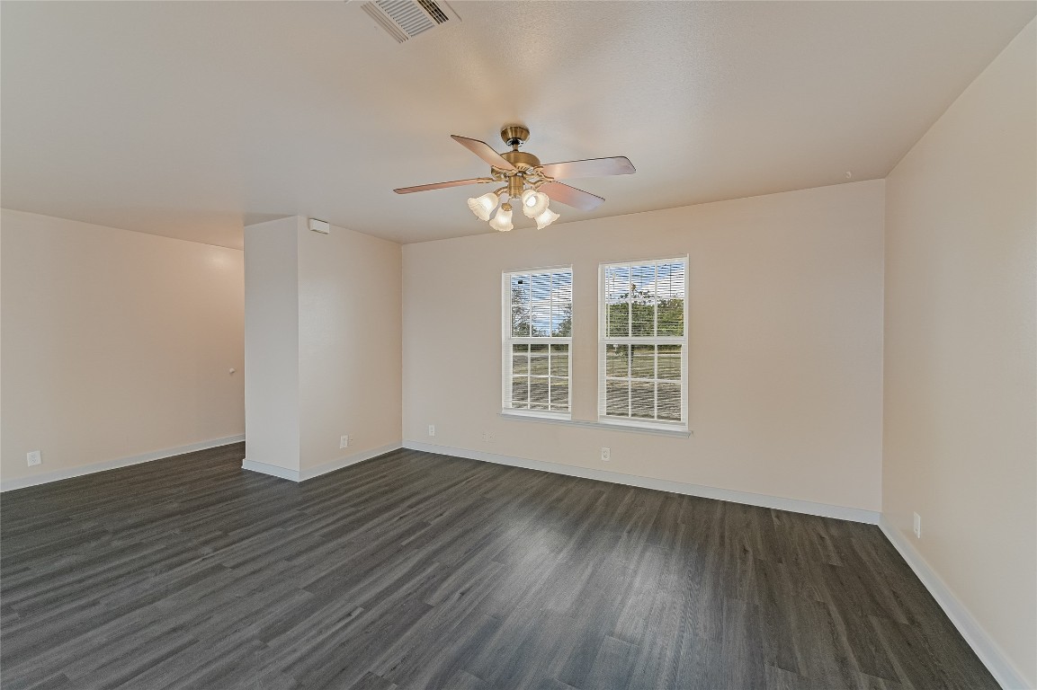 200 Creekside Trail Kyle, TX 78640 - Photo 10 of 19 a view of an empty room with wooden floor and a window