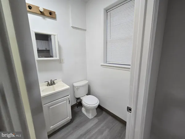 a bathroom with a toilet sink and a mirror