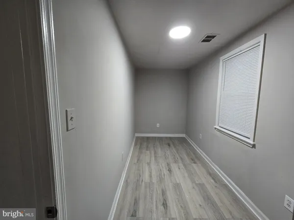 a view of room with window and hardwood floor