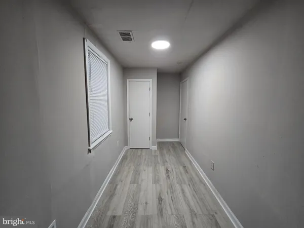a view of wooden floor in a hallway