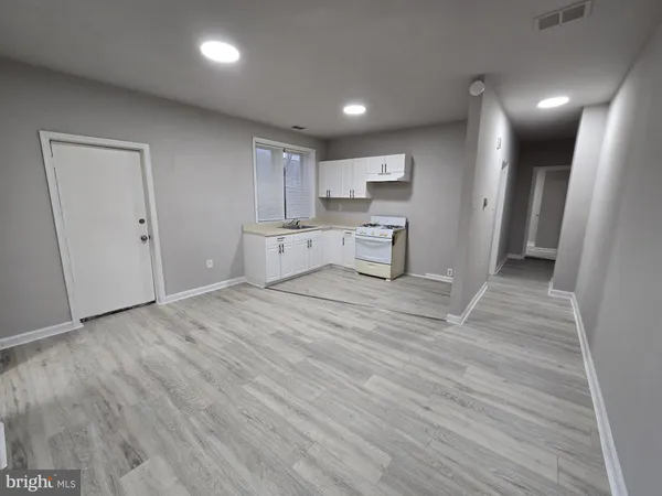 a view of a kitchen with a sink and a refrigerator