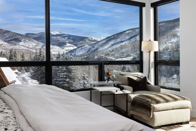 a bedroom with furniture and a large window