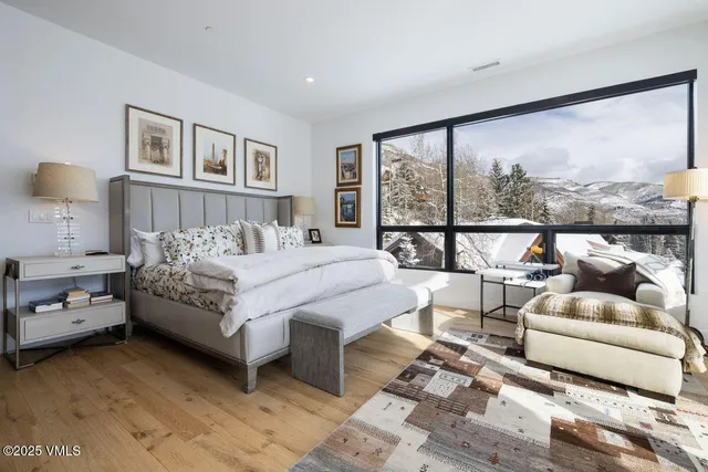 a bedroom with a bed and glass window
