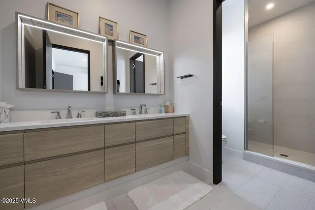 a bathroom with a tub sink and mirror