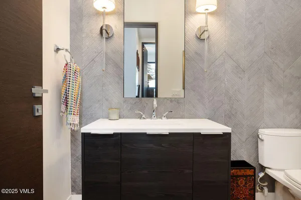 a bathroom with a sink vanity and mirror