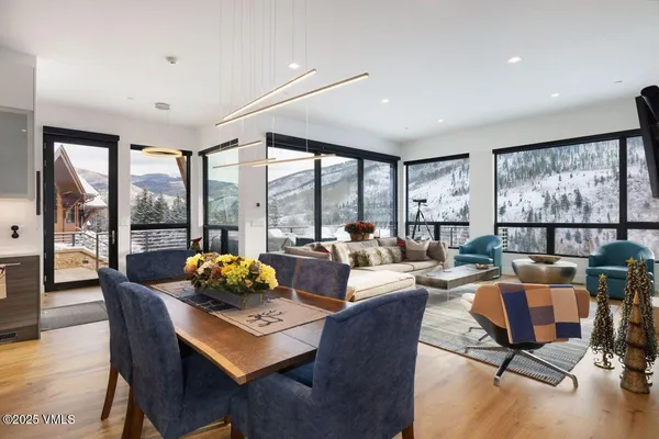 a living room with furniture and large windows