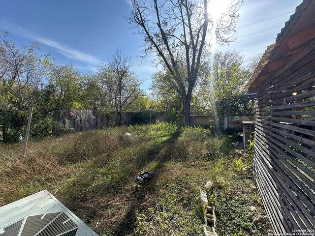 a view of a backyard with sitting area