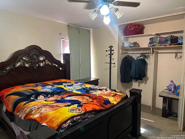 a bedroom with a bed and a chandelier