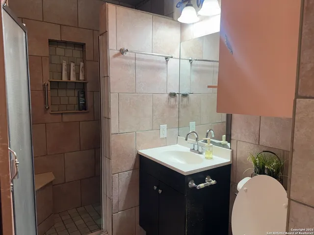 a bathroom with a sink vanity and a mirror