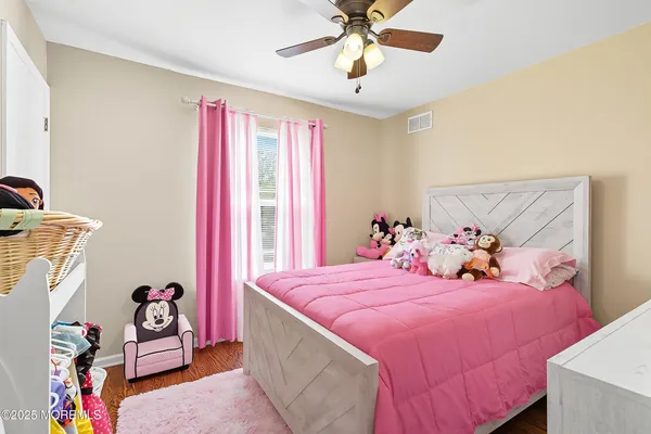 a bedroom with bed and a chandelier
