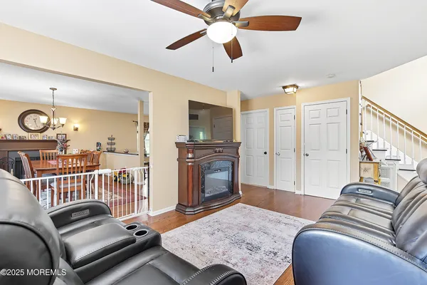 a living room with furniture fireplace and flat screen tv