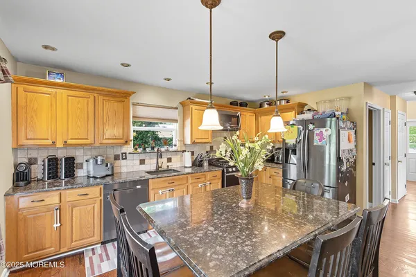 a kitchen with stainless steel appliances granite countertop sink stove and cabinets