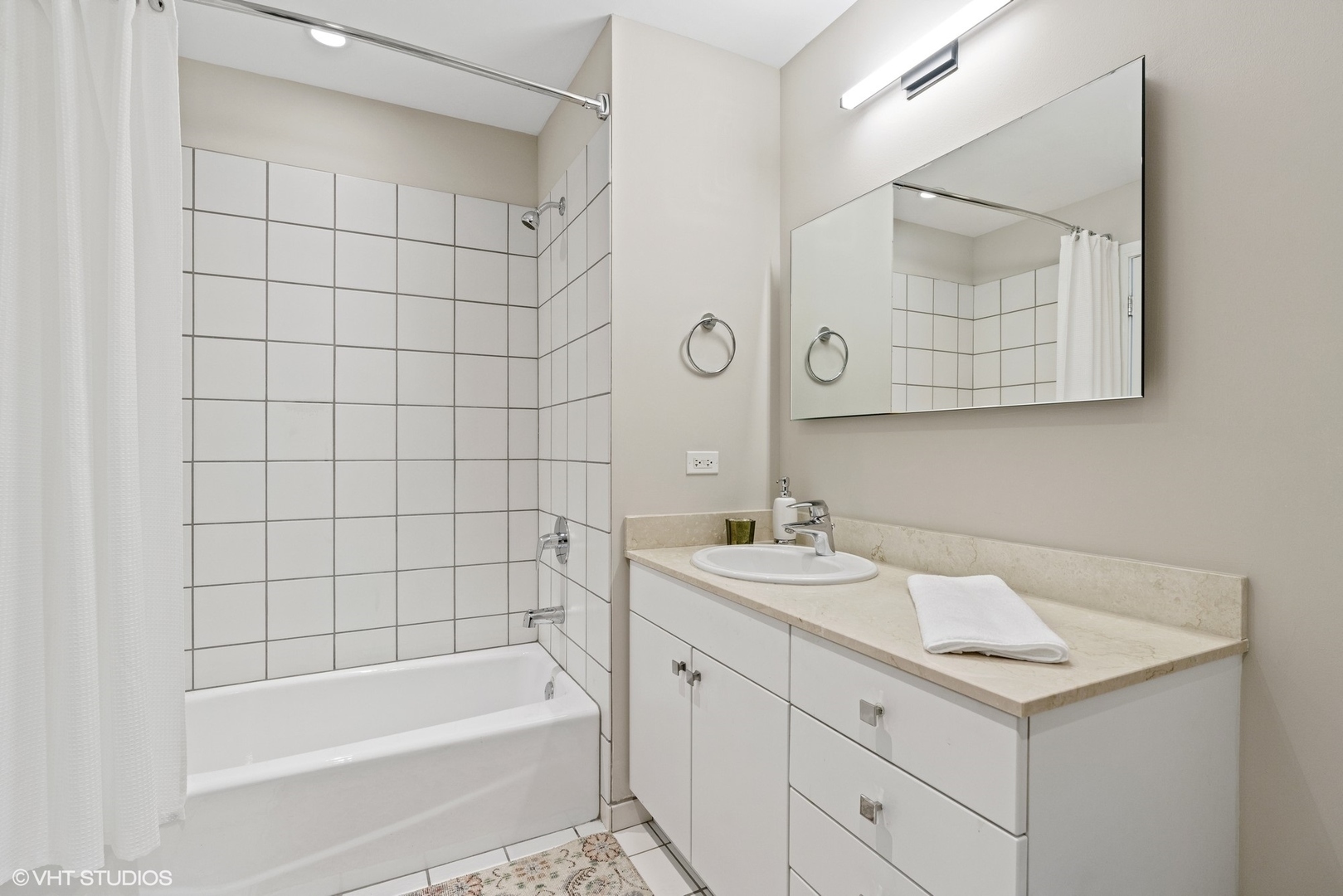 8 East Randolph Street, Unit 3207 Chicago, IL 60601 - Photo 13 of 16 a bathroom with a sink a vanity a mirror a bathtub and shower
