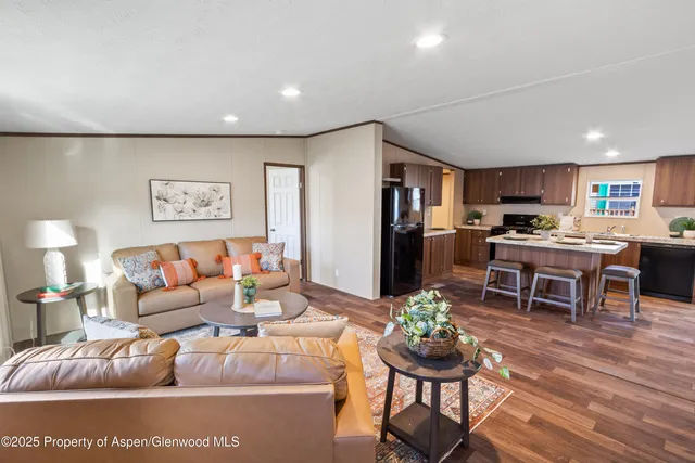 a living room with furniture and kitchen view