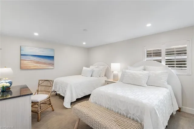 a large bedroom with two beds and a desk