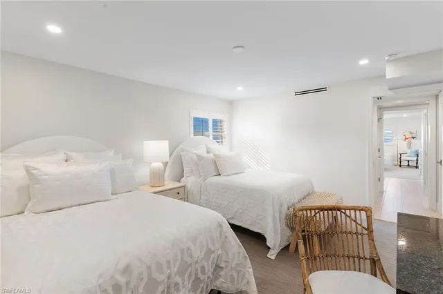 a bedroom with two beds and a couch