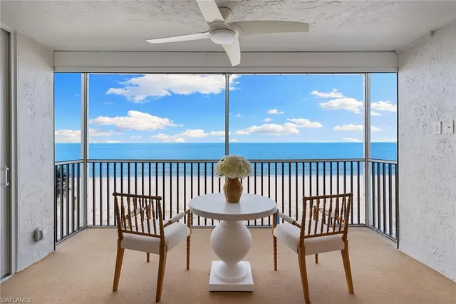 a view of a porch with a table and chairs