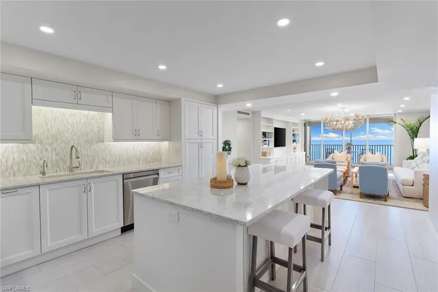 a kitchen with counter and chairs