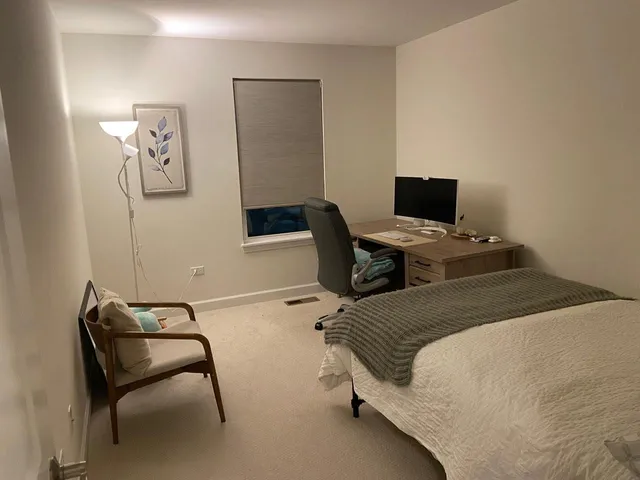 a bedroom with a bed and a chair