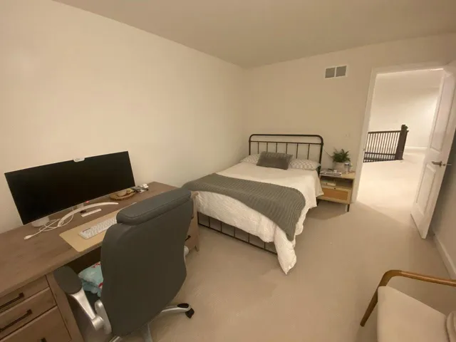 a bedroom with a bed and computer
