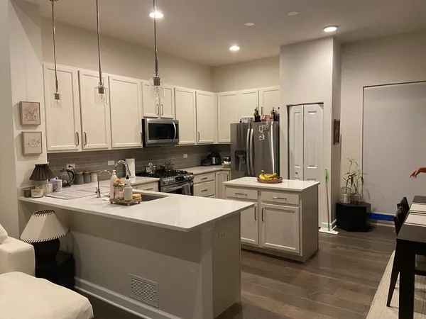 a kitchen with a sink appliances and cabinets