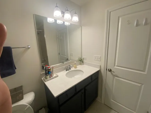 a bathroom with a sink vanity granite and a mirror