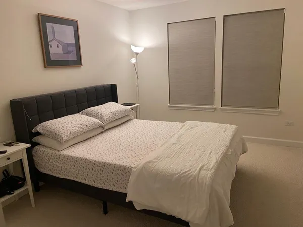 a bedroom with a bed and a table