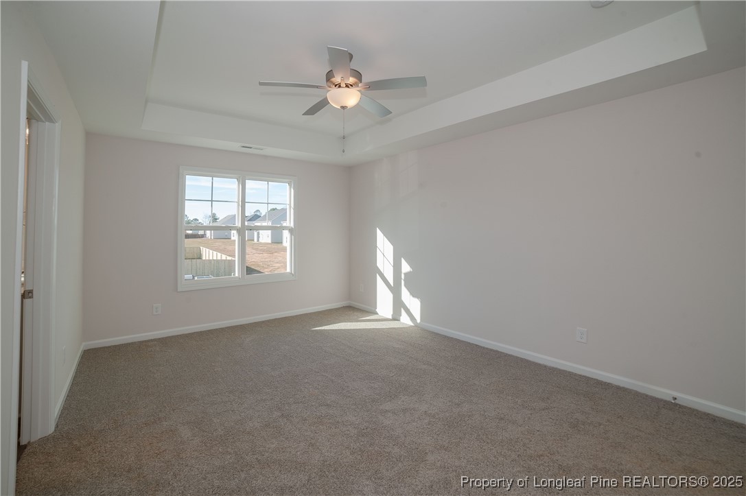 164 Ziggy Way Raeford, NC 28376 - Photo 13 of 25 an empty room with windows and fan