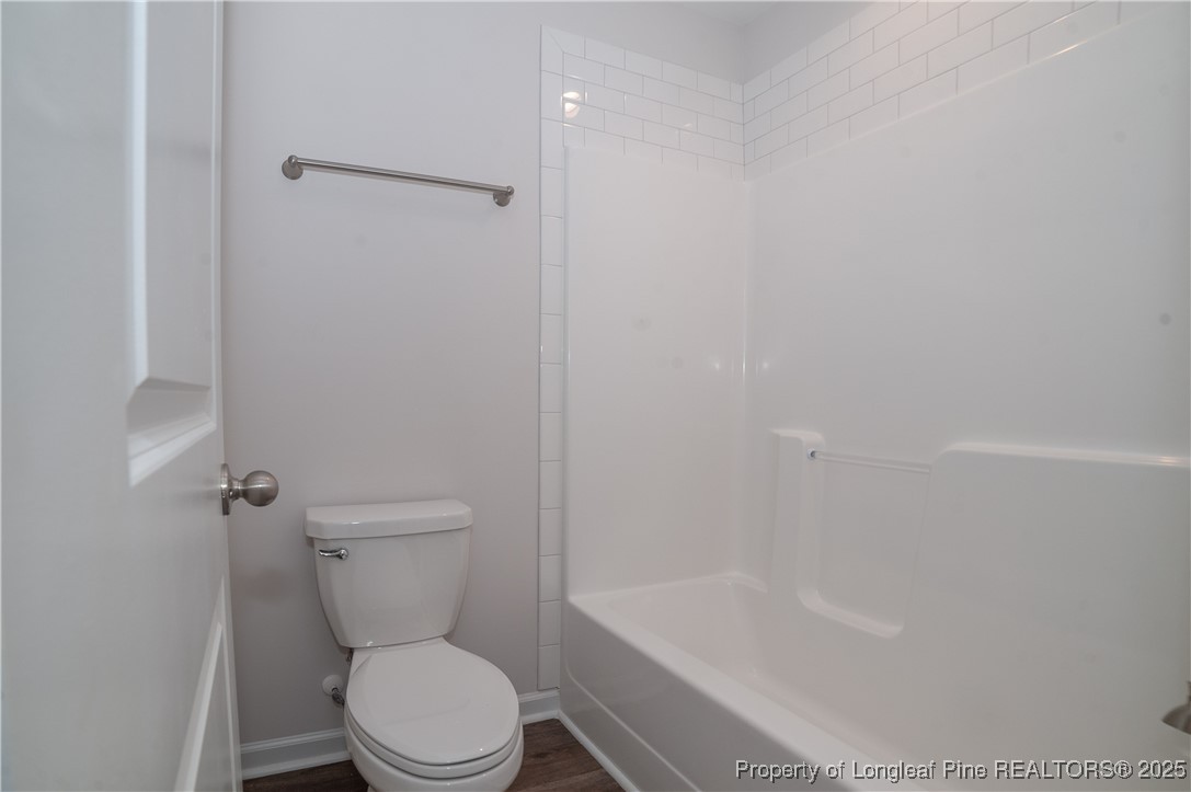 164 Ziggy Way Raeford, NC 28376 - Photo 21 of 25 a white toilet sitting next to a bath tub