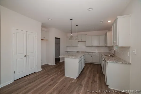 a kitchen with a sink window and cabinets
