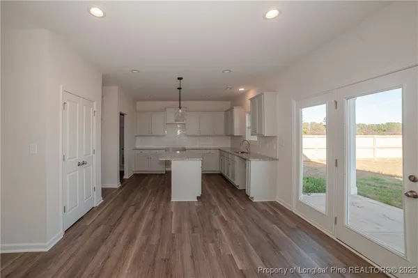 a kitchen with stainless steel appliances a sink a stove a refrigerator and cabinets