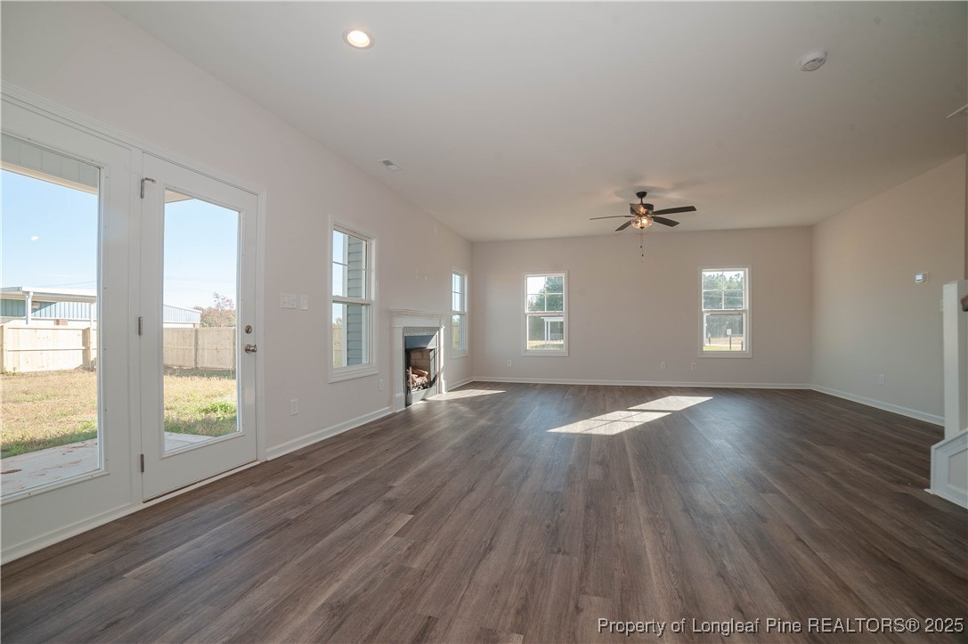 164 Ziggy Way Raeford, NC 28376 - Photo 7 of 25 an empty room with wooden floor and windows
