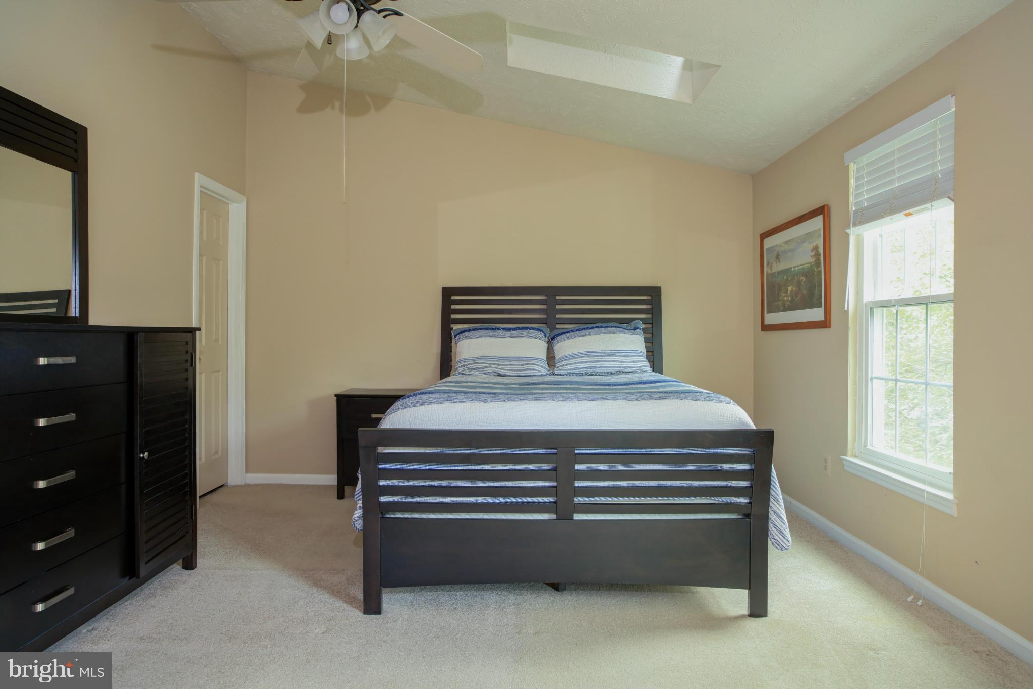 1595 Autumn Ridge Circle Reston, VA 20194 - Photo 14 of 26 a bedroom with a bed and a dresser