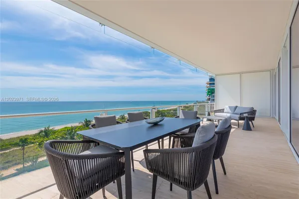 a view of a roof deck with furniture