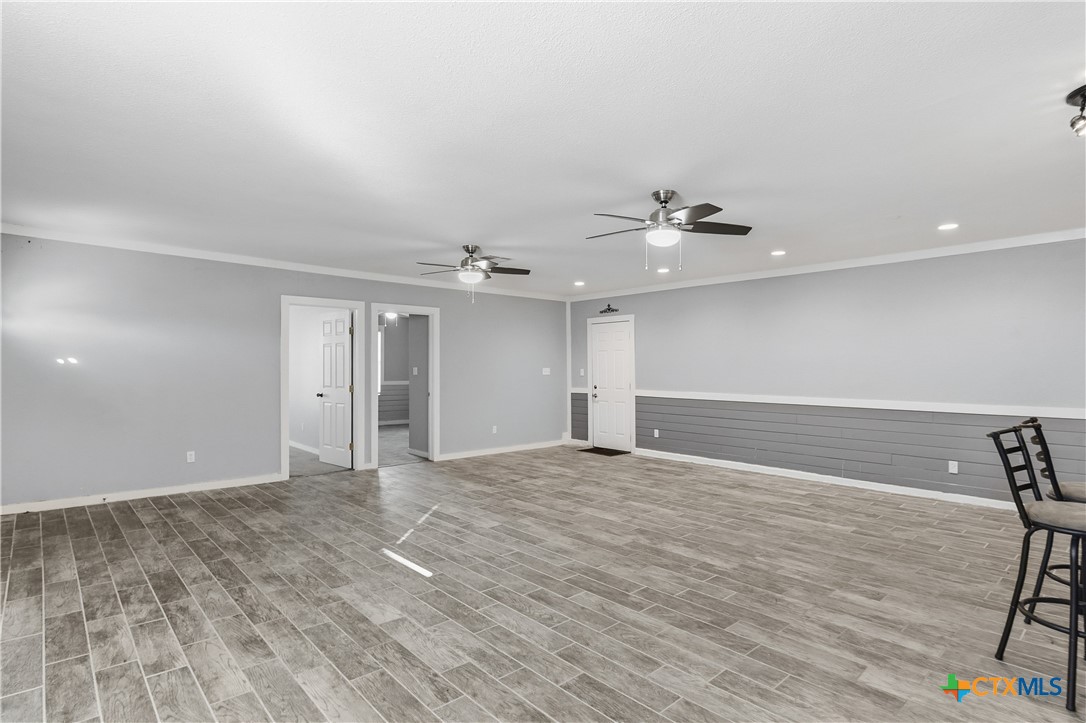 332 West Klein Street Seguin, TX 78155 - Photo 3 of 24 wooden floor in an empty room with a window