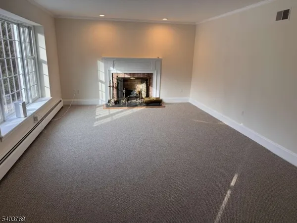 a view of empty room with a fireplace